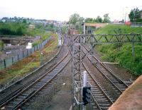 View looking west from Gartsherrie Road over Sunnyside Junction in 1987. The line running off to the south is the freight only link to Whifflet South Junction. The line turning north under the bridge alongside the signal box latterly served Gartsherrie cement works and Gunnie Yard. The land beyond the fence on the left is part of Summerlee Heritage Museum.<br><br>[Ewan Crawford //1987]