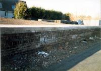 Southbound platform face of the island platform at Kilbarchan seen from the trackbed. The northern station entrance ramp is to the right. Sustrans had just finished repairing the platform brickwork and added a new platform edge.<br><br>[Ewan Crawford //1987]
