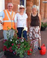 Volunteers at Dumfries station in July standing alongside some of the striking floral displays that now adorn the platforms.<br><br>[ScotRail /07/2013]