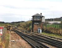 The train emerging from the siding is for Queen Street. It will go through the crossover, stop at the Cumbernauld platform then leave at 1444. Note the CR style of railed balcony on the Signal box.<br><br>[Brian Forbes //1993]