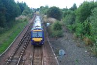 An eastbound train passes the former Bishopbriggs oil terminal (right) and is about to enter Cadder Yard.<br><br>[Ewan Crawford 22/09/2006]