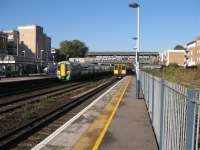 A northbound Southern unit heads towards Watford Junction, whilst a southbound Silverlink unit heads towards Clapham Junction.<br><br>[Michael Gibb 04/11/2006]