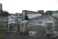 Looking east to Scotstoun West station. This fine girder bridge looks to be in a state of siege. Doocots abound round here.<br><br>[Ewan Crawford 09/01/2006]