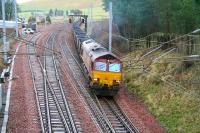 EWS 66025 brings the 1155 Chalmerston - Rugeley coal train out of the up loop at Abington and onto the WCML on 31 January 2007 having been sidelined for a passing Pendolino.<br><br>[John Furnevel 31/01/2007]