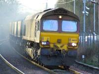 A very smoky 66143 passing through Johnstone with loaded coal hoppers.<br><br>[Graham Morgan 24/01/2007]