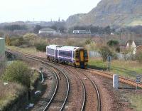 Diverted westbound train heading for Bathgate crosses Niddrie West Junction in the shadow of Arthurs Seat on 31 March.<br><br>[John Furnevel /03/2007]
