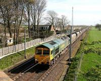Northbound coal empties passing the site of Rockcliffe station just north of Carlisle in April 2007. The much modified former station house still stands on the left and the floodlights of Kingmoor yard can be seen in the right background.<br><br>[John Furnevel 18/04/2007]