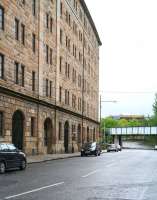 Looking east along Bell Street in May 2007, showing the former College Goods warehouse. The plate girder bridge carries the CGU line north towards High Street East Junction, with the entrance to the old Gallowgate station just off picture to the right below the bridge [see image 14887].<br><br>[John Furnevel 06/05/2007]