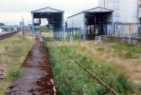Abandoned grain silo sidings at Muir of Ord looking north 1n 1989. Note Muir of Ord North signalbox in the left background.<br><br>[Ewan Crawford //1989]