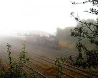 A <I>touch of fog</I> over North Lancs on 13 October as an ethereal 48151 departs Carnforth past the Virtual Quarry sidings. <br><br>[John McIntyre 13/10/2007]