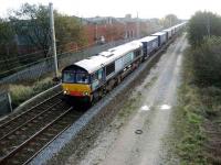 A DRS class 66 with the Tesco containers at Coppull, Lancs on 9 November heading for Grangemouth. <br><br>[John McIntyre 09/11/2007]