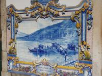 A close up of one of the many tile pictures on the exterior walls of Pinhao station. This one depicts a scene in the Douro Valley with Port barrels being loaded onto a boat, for transport downstream to Porto and export probably.  <br><br>[Mark Bartlett 04/02/2007]
