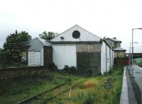 Looking north over the down platform and part of the former goods yard and sheds at Markinch in July 1998. The original 1847 E&N station building in the background still stands although operational activities are now handled by a modern interchange recently opened on the site of the former yard.<br><br>[David Panton /07/1998]