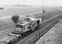 Rolls Royce engined <I>Clayton</I> class 17 D8587 photographed just beyond Niddrie West Junction on the Millerhill line with a PW train c 1971.  Running in parallel is the former direct route to Wanton Walls and the ECML, closed a short time later.<br><br>[Bill Roberton //1971]