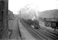 A3 Pacific no 60075 <I>St Frusquin</I> climbs away from the Hawick stop past Loch Park PW depot with the up <I>Waverley</I> for London St Pancras in June 1959. [See image 45325]<br><br>[Robin Barbour Collection (Courtesy Bruce McCartney) 18/06/1959]