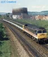 Class 47 hauled passenger train passing south past the site of Stirling MPD.<br><br>[Ewan Crawford //]