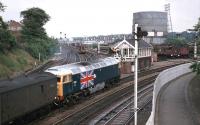 1977 was the Queens Jubilee year and Stratford MPD's contribution was to apply Union Jacks to the sides of 47163 and 47164. The latter is seen here departing Norwich Thorpe for London in June 1977. Sister engine 47163 was involved in a fatal collision later that year. The signal box lasted until August 1988. <br><br>[Mark Dufton 27/06/1977]