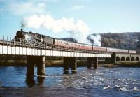 Standard class 5 no 73146 brings the 10am Dundee - Glasgow Buchanan Street train over the Tay at Perth in 1965. The locomotive was one of the batch fitted with Caprotti valve gear and allocated to St Rollox shed.<br><br>[Robin Barbour Collection (Courtesy Bruce McCartney) 29/10/1965]
