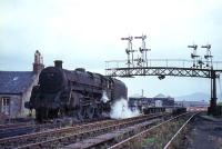 View of Princes Pier station framed in the gantry of GSWR signals in August 1965 as 73104 awaits the arrival of its train.<br><br>[G W Robin 25/08/1965]