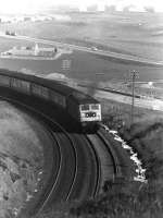 A class 47 hauls a southbound service out of Aberdeen past Nigg Bay in April 1979.<br>
<br><br>[John McIntyre 11/04/1979]