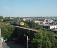 The low viaduct immediately east of Nelson station sees Northern Rail Pacer 142040 crossing on its way to the terminus at Colne against the backdrop of the town.<br><br>[Mark Bartlett 26/09/2008]