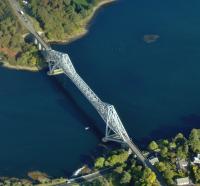 Aerial view of the Connel bridge on 5 October 2008. The bridge was built by Arrols Bridge & Roof Co [see image 18249] to carry the Ballachulish branch of the Callander & Oban Railway over Loch Etive and opened on 20 August 1903. A roadway was added alongside the line in 1914. The Ballachulish branch closed in 1966 and today the bridge carries single file road traffic controlled by traffic lights.<br><br>[Brian Smith 05/10/2008]