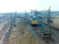 The locomotive facilities serving the massive coal concentration yard at Wath (BR shed code 41C), between Barnsley and Doncaster, in February 1981. The yard opened in 1907 and, at its peak, served no less than 45 collieries operating within a 10 mile radius of the site. As well as diesel locomotives, several EM1 electrics built to haul the heavy coal trains west over the Pennines via Woodhead Tunnel can be seen. The Woodhead route closed less than 6 months after this picture was taken, with the last train running over the line on 17 July 1981. Wath shed was eventually closed in 1983 and the yard itself in 1988, along with the last of the local collieries.<br><br>[Colin Alexander 01/02/1981]