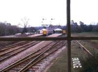 The local branch train for Tunbridge Wells West stands in the bay at Eridge, as a through service arrives at the platform to the left. Photographed from the signal box in March 1985, just 4 months before closure of the branch line. Much of the former branch is now in the hands of the Spa Valley Railway who plan to re-establish services over its whole length in the near future.<br><br>[Ian Dinmore 22/03/1985]