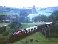 Ivatt Ex-LMS Class 2 2-6-2T 41241 takes a train across Mytholmes viaduct, spanning the River Worth on the KWVR in the 1960s. The train is just about to enter the short tunnel on the climb towards Haworth.<br><br>[Robin Barbour Collection (Courtesy Bruce McCartney) //]