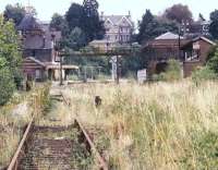 The scene at Tunbridge Wells West in November 1985, some 4 months after closure, with much of the old station having been badly burnt out by vandals. The former branch from Eridge is now in the hands of the Spa Valley Railway. [See image 42265]<br><br>[Ian Dinmore 16/11/1985]