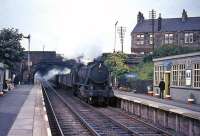 Ex-WD Austerity 2-8-0 No 90547 brings an up freight through Cumbernauld station in August 1965.<br><br>[G W Robin 03/08/1965]