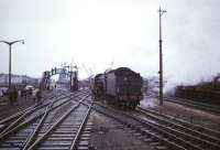 Ex-LNER B1 4-6-0 no 61342 of Eastfield shed brings <I>Scottish Rambler No 5</I> back from Ardrossan's Montgomerie Pier on 10 April 1966 towards the platforms of Ardrossan North station, from which the photograph was taken. The line over the level crossing below the footbridge provided a link with the G&SW system which ran to Winton Pier.<br><br>[Robin Barbour Collection (Courtesy Bruce McCartney) 10/04/1966]