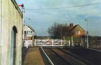 A quiet Easter Saturday morning at Thorpe Culvert station on the Skegness Branch looking past the level crossing and signal box towards Firsby. <br><br>[Mark Bartlett 02/04/1994]