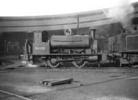 Drummond 0-4-0ST no 56038, minus wooden tender, comes off the turntable at Inverness in March 1959. The semi-circular open roundhouse closed in 1962 and was demolished the following year. <br><br>[Robin Barbour Collection (Courtesy Bruce McCartney) 25/03/1959]