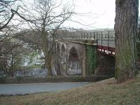 <I>Scene of a very expensive argument</I>. The bridge at Ingleton should have provided a through link from Yorkshire to Scotland. However, because it formed an end on junction between the Midland Railway and the LNWR, who were in dispute in the 1860's, that never transpired and the animosity between the two companies meant that through passengers arriving at one station would have to make their own way through the gorge to the station on the other side. In due course the Midland constructed the Settle and Carlisle Railway to avoid reliance on the LNWR instead. This view looks north from the site of the North Western station, now covered by a community centre and its car park although the viaduct, which last carried trains in 1966, is still in excellent condition.<br><br>[Mark Bartlett 31/01/2009]