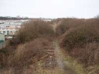 <I>End of the line</I>. The disused former Fleetwood line peters out about one mile north of Burn Naze and this view towards Wyre Dock and Fleetwood shows the last few yards of track, finally used by coal trains to Fleetwood Power Station in the 1980s. Long demolished Fleetwood steam shed was in the middle distance on the left hand side of the line. Photo taken from an overbridge at Map Ref <br>
SD 329455. <br><br>[Mark Bartlett 17/02/2009]