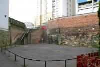 On leaving North Leith, the EL&N line entered a tunnel running under Coburg Street, emerging alongside the Water of Leith and the first stop at Junction Bridge (renamed from Junction Road in 1923). The north end of the tunnel, seen here from the station site in March 2009, has been bricked up and a play area formed, with stone steps now installed to provide a link across to Coburg Street.     <br>
<br><br>[John Furnevel 15/03/2009]