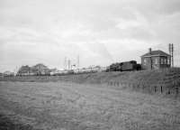An eastbound coal train heads for Kincardine power station behind an ex-WD  Austerity locomotive in the 1960s. The train is about to pass Kincardine Junction signal box and turn south to cross the A907 on (the old) Helensfield Bridge.<br><br>[Robin Barbour Collection (Courtesy Bruce McCartney) //]