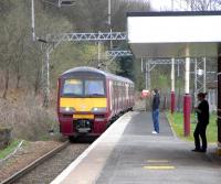 A Balloch - Airdrie train, formed by 320 311, arives at Renton on 1 April 2009.<br><br>[David Panton 01/04/2009]