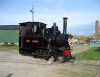 O&K 0-4-0T+WT <I>Montalban</I> in the guise of <I>Monty the Friendly Engine</I>, running round the train at Becconsall on the West Lancashire Light Railway on 5 April 2009. The chimney in the background shows the original use of this site, a brick works with its own clay pit.<br>
<br><br>[John McIntyre 05/04/2009]