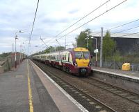 A 6-car 334 set pulls into Shieldmuir with the hourly Lanark direct service on 29 April. A new housing development is now underway on land off to the left once occupied by part of the former steelworks.<br><br>[David Panton 29/04/2009]