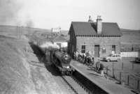 62471 <I>Glen Falloch</I> arrives at Gordon, Berwickshire, from Greenlaw, with the <I>Scott Country Rail Tour</I> on 4 April 1959. The station had been closed to passengers since 1948, although the goods yard is still active, with stone from local quarries being loaded in the background. The line from Ravenswood Junction was finally closed in 1965.<br><br>[Robin Barbour Collection (Courtesy Bruce McCartney) 04/04/1959]