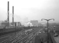 <I>Scottish Rambler no 5</I> at Ardrossan North on 10 April 1966 during the trip from Glasgow Central to Montgomerie Pier. The locomotive in charge is Eastfield B1 no 61342. The view is east from the footbridge spanning the spur to the junction with the G&SW route to Winton Pier. The lines to Montgomerie Pier run off to the left. The station building had been demolished by this time with the site being used for parking. Dominating the background is the large Shell refinery and its associated sidings. Production there ceased in 1986. [See image 15068] <br>
<br><br>[K A Gray 10/04/1966]
