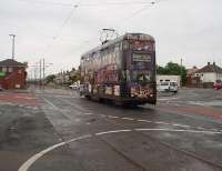 Heading for the Starr Gate southern terminus No. 707, a 1930s double deck <I>Millennium</I> car with a new body on the original frames, leaves Broadwater tram stop and crosses the busy road before rejoining the independent section of track that runs across fields to Rossall School. This location changed significantly when the tramway was refurbished and a level access tram stop behind the camera position replaced the original.  <br><br>[Mark Bartlett 10/06/2009]