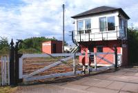 The level crossing and signal box at Holywood, on the G&SW route north of Dumfries, seen here looking east on 10 June. Holywood is one of the reducing number of crossings in the UK where the gates continue to be operated manually by the signalman, using a wheel located within the box.<br>
<br><br>[David Forbes 10/06/2009]