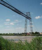 Similar in operation to, but 11 years older than, its Middlesbrough counterpart [See image 59948] this is Rochefort transporter bridge over the River Charente. Built in 1900 it has been replaced by a motorway viaduct in recent years but still operated by the local government region as a preserved industrial monument.<br><br>[Mark Bartlett 24/06/2009]