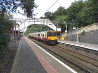 Looking across the tracks towards the northbound platform at Bearsden on 8 August as 318 259 arrives on a service for Milngavie.<br><br>[David Panton 08/08/2009]