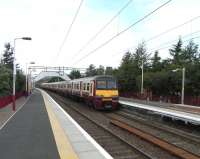 A six car 320 formation arrives at Clydebank on 8 August 2009, destination Springburn. The named sets are <I>High Road 20th Anniversary 2000</I> followed by <I>Royal College of Physicians and Surgeons of Glasgow</I>.<br>
<br><br>[David Panton 08/08/2009]