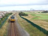 The line between Squires Gate and the outskirts of St Annes passes through an open area of sand dunes where Blackpool Airport and the St Annes Old Links Golf Club are also situated. 142007 is on a Blackpool South to Colne service and the distinctive Blackpool skyline can be seen behind the train as it runs towards St Annes station. <br><br>[Mark Bartlett 11/08/2009]