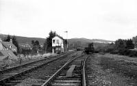 Looking north towards Grantown on Spey with Boat of Garten North signal cabin standing over the remaining track work on 06 April 1973 in the early days of preservation by the Strathspey Railway. The point on the right had connected to the ex GNoSR line to Nethy Bridge but the scrapmen had truncated it just beyond the ex CR crane. The reason for the facing point lock here was to permit passenger services to run through from Aviemore to Craigellachie when the Speyside service was extended from Boat of Garten in BR days. On the ex HR line, a rail has been removed from each side beyond the point and at the north end of the loop the track had been lifted immediately after the point.<br><br>[John McIntyre 06/04/1973]